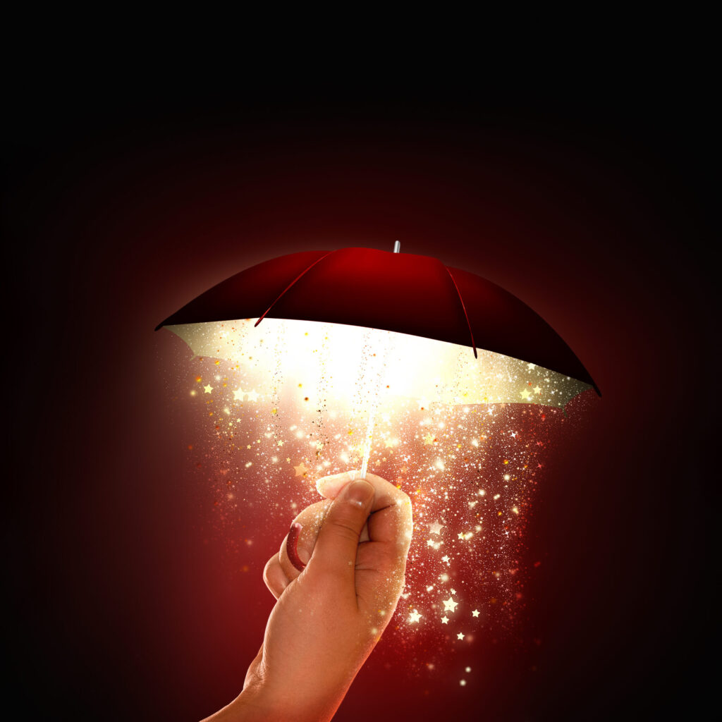 hand holds a bright umbrella with a magical glow